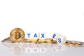 Conceptual cryptocurrency bitcoin with word Taxes breaking up