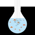 A group of fish in a light bulb shaped container. Royalty Free Stock Photo