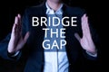 Conceptual display Bridge The Gap. Conceptual photo Overcome the obstacles Challenge Courage Empowerment Man pointing