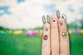 Conceptual easter finger art. Person with a two bunnys is holding two painted eggs. Stock Image