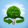 Conceptual eco energy. Lamp and green arrows from the grass. Recycling concept Royalty Free Stock Photo