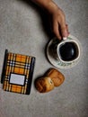 conceptual entertainment a glass of coffee two pieces of bread and work equipment on the table in the dining room Royalty Free Stock Photo