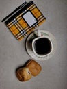 conceptual entertainment a glass of coffee two pieces of bread and work equipment on the table in the dining room Royalty Free Stock Photo