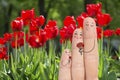 Conceptual family finger art. Father and son are giving flowers his mother. Stock Image.