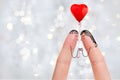 Conceptual finger art of a Happy couple. Lovers are kissing and holding red balloon. Stock Image