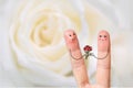Conceptual finger art of a Happy couple. Man is giving a bouquet. Stock Image