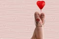 Conceptual finger art. Lovers are embracing and holding bouquet of red hearts. Stock