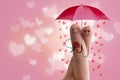 Conceptual finger art. Lovers are embracing and holding umbrella with falling hearts. Stock Image