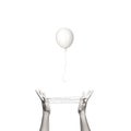 Conceptual freedom image of a white balloon escaping from a human trap Royalty Free Stock Photo