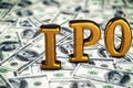 Conceptual golden abbreviation of IPO standing or lying on money dollars banknotes background. 3D Render.