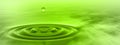 Conceptual green liquid drop falling in water banner Royalty Free Stock Photo