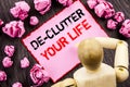 Conceptual hand text showing De-Clutter Your Life. Concept meaning Free Less Chaos Fresh Clean Routine written on Sticky Note Hold Royalty Free Stock Photo