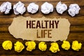 Conceptual hand text word Healthy Life. Business concept for Good Health Food Written on sticky note, wooden with sticky, many fol Royalty Free Stock Photo