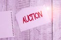 Conceptual hand writing showing Auction. Business photo text Public sale Goods or Property sold to highest bidder Purchase Torn