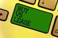Conceptual hand writing showing Buy Vs Lease. Business photo text Own something versus borrow it Advantages Disadvantages Keyboard