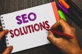 Conceptual hand writing showing Seo Solutions. Business photo text Search Engine Result Page Increase Visitors by Rankings Man hol