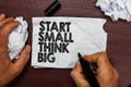 Conceptual hand writing showing Start Small Think Big. Business photo text Initiate with few things have something great in mind H Royalty Free Stock Photo