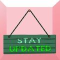 Conceptual hand writing showing Stay Updated. Business photo text keep modern recent or containing the latest information Wood