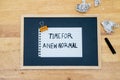 Conceptual hand writing showing Time For A New Normal, on white paperclip hold written chalkboard on wooden deck