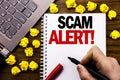 Conceptual hand writing text caption Scam Alert. Business concept for Fraud Warning Written on tablet laptop, wooden background wi Royalty Free Stock Photo