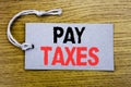 Conceptual hand writing text caption showing Pay Taxes. Business concept for Taxation Overtax Return written on price tag paper wi