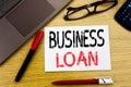 Conceptual hand writing text showing Business Loan. Business concept for Lending Finance Credit written on paper, wooden backgroun