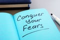 Conceptual hand writing text showing Conquer your fears