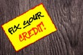 Conceptual hand writing text showing Fix Your Credit. Concept meaning Bad Score Rating Avice Fix Improvement Repair written on Yel Royalty Free Stock Photo