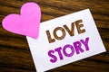 Conceptual hand writing text showing Love Story. Concept for Loving Someone Heart written on sticky note paper, wooden wood backg Royalty Free Stock Photo