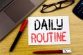 Conceptual hand writing text showing Daily Routine. Business concept for Habitual Lifestyle written on paper, wooden background in