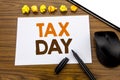 Conceptual hand writing text showing Tax Day. Business concept for Income taxation Refund written on sticky note paper on the wood Royalty Free Stock Photo