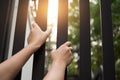 Conceptual hope Hands of the prisoner on a steel jail with the s Royalty Free Stock Photo