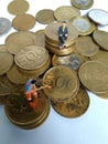 Conceptual Illustration for Money Laundry Activity, worker mini figure toy cleaning golden indonesia rupiah coin