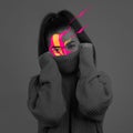Conceptual image with black and white portrait of young girl with bright colored spots on her face. Concept of mental