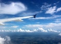 Gorgeous blue skies with heavy cloud cover seen from jet window seat