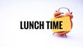 Conceptual image of Business Concept with words Lunch Time on a clock with a white background. Selective focus. Royalty Free Stock Photo