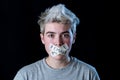 Conceptual image of censorship and gender identity. Transgender teenager with mouth sealed