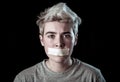 Conceptual image of censorship and social tabu. Transgender teenager with mouth sealed