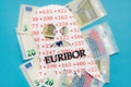 Conceptual image of Euribor as in scary monster floating above Euro money. Royalty Free Stock Photo