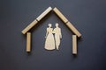 Conceptual image of family values and adoption. House from wooden blocks on beautiful grey background. Family sign Royalty Free Stock Photo