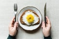 Conceptual image of fried egg toast with yellow chrysanthemum flower instead of yolk served on a white plate Royalty Free Stock Photo