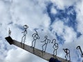 Conceptual image of a group of people climbing a ladder with blue sky background Royalty Free Stock Photo