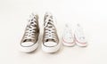 Family sneakers canvas shoes of father and child on white in single parent family concept Royalty Free Stock Photo