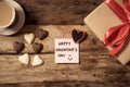 Conceptual image of Happy Saint valentines day with post it note, heart shaped chocolate and coffee Royalty Free Stock Photo