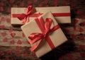 Conceptual image of Happy Saint valentines day wrapped gifts and red hearts on wooden vintage table