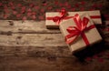 Conceptual image of Happy Saint valentines day wrapped gifts and red hearts on wooden vintage table