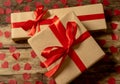 Conceptual image of Happy Saint valentines day wrapped gifts and red hearts on wooden vintage table