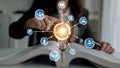 Conceptual Image of Innovation and Learning with Light Bulb, Digital Icons, and Open Book Symbolizing Knowledge and Royalty Free Stock Photo