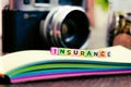 Conceptual image with INSURANCE word block on note pad over soft Royalty Free Stock Photo