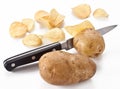 Conceptual image - the knife cuts fresh potatoes